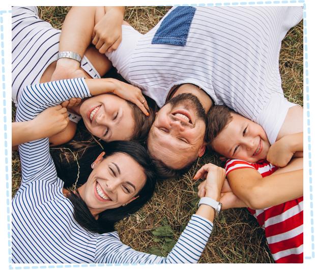 Happy family lying on grass hugging