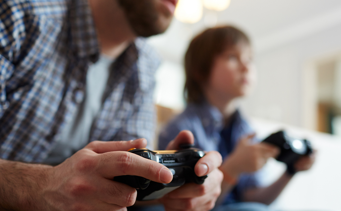 Father and son playing video games