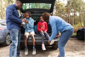 family outside car