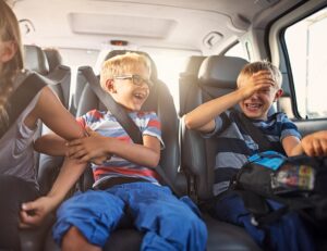 How do travel sickness tablets work? 9 two boys laughing in the back of a car
