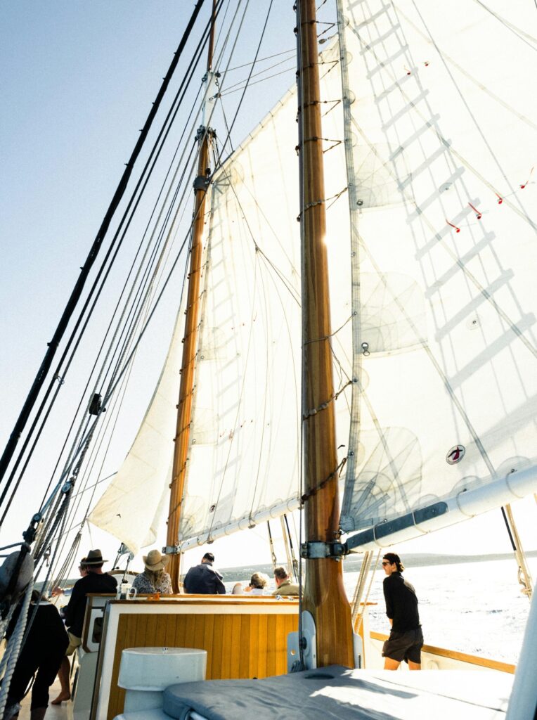 people standing on a large sailboat